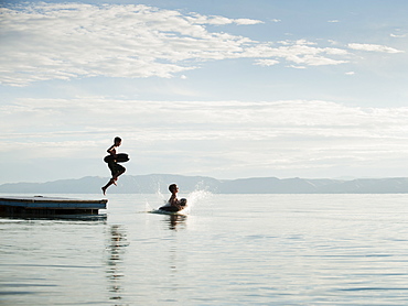 Boys (10-11,12-13) jumping from raft