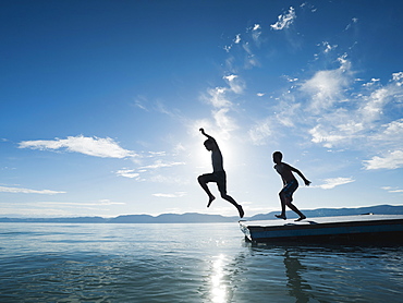 Boys (10-11,12-13) jumping from raft