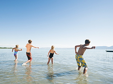 Kids (6-7,8-9,10-11,12-13) playing in lake