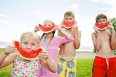 Kids (6-7,8-9,10-11,12-13) eating watermelon