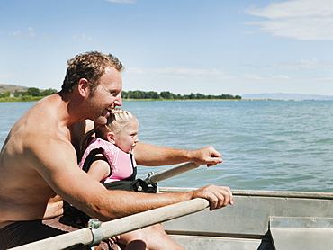 Father and daughter (2-3) on boat