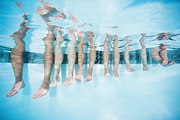 Family with four kids (12-18months, 4-5,6-7,8-9) on swimming pool