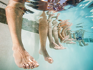 Family with four kids (12-18months, 4-5,6-7,8-9) on swimming pool