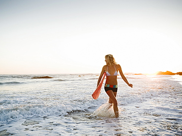 Portrait of woman with surfboard