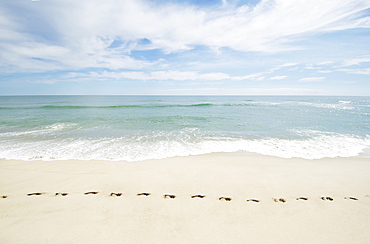 Footprints on empty beach