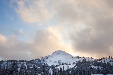 Snow covered mountain peak with late evening sky, USA, Utah, Big Cottonwood Canyon