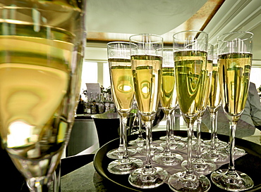 Chapmagne flutes on tray in restaurant, Europe