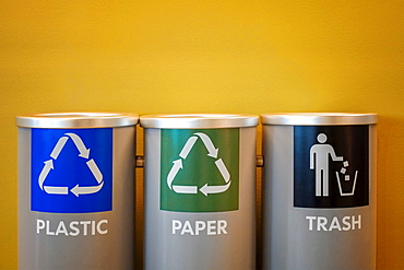 Recycling bins on yellow background