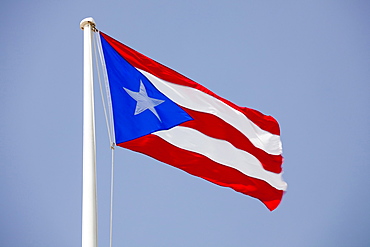 Morro Castle, Puerto Rican flags flying against blue sky, El Morro, San Juan, Puerto Rico