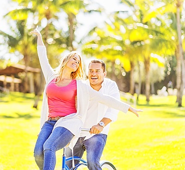 Couple riding on bike, Jupiter, Florida