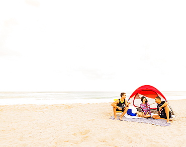 Young people relaxing on beach, Jupiter, Florida