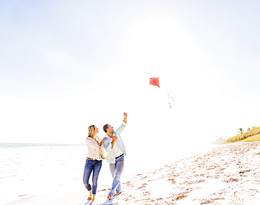 Couple on beach with kite, Jupiter, Florida