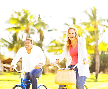 Couple riding on bikes, Jupiter, Florida