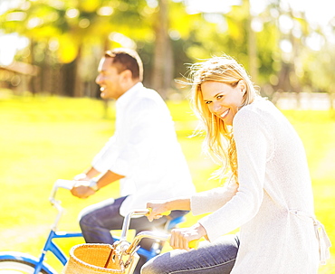 Couple riding on bikes, Jupiter, Florida