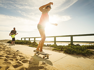 Parents skateboarding with their son (6-7), Laguna Beach, California