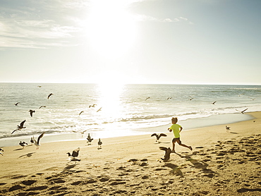 Boy (6-7) running on beach, Laguna Beach, California