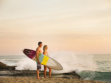 Mid-adult couple looking at sea, Laguna Beach, California