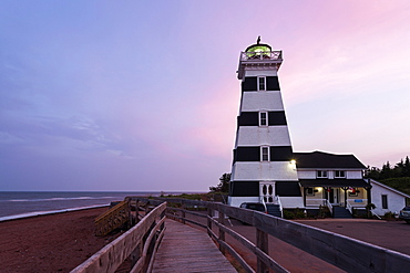 West Point Lighthouse and sandy beach at dusk, Prince Edward Island, New Brunswick, Canada