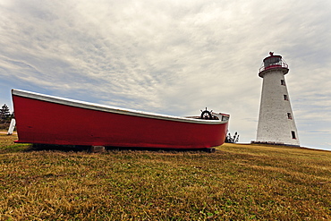 Low angle view of Point Prim Lighthouse and red boat, Prince Edward Island, New Brunswick, Canada