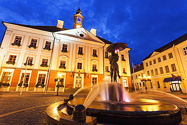 Kissing Students Fountain against illuminated building, Estonia