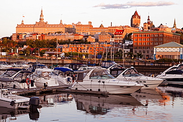 Speedboats moored at marina and cityscape in background, Quebec, Canada