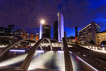 Illuminated skyline with empty ice rink in foreground, Toronto, Canada