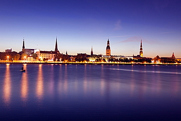 View of city from river at night, Latvia