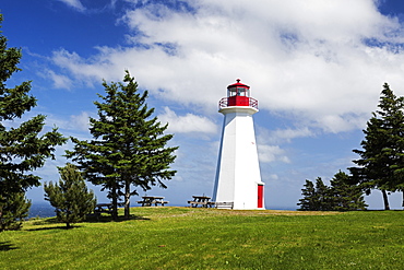 Cape George Lighthouse on grassy hill, Nova Scotia, Canada