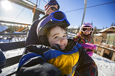 Father skiing with children (6-7, 8-9), Whitefish, Montana USA