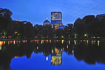 Skyline of Copley Square Boston reflecting in pond of Public Gardens at dusk, Boston, Massachusetts