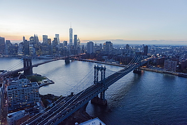Lower Manhattan, View of Brooklyn Bridge and One World Trade Center at dusk, New York, New York