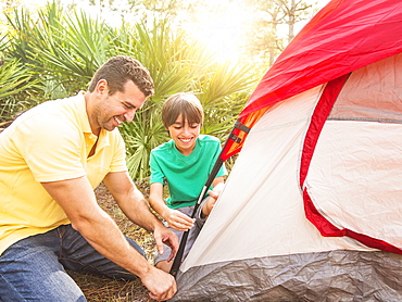 Father and son (12-13) setting up tent, Jupiter, Florida