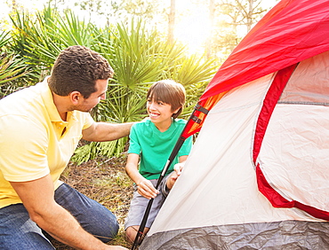 Father and son (12-13) setting up tent, Jupiter, Florida