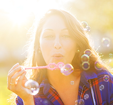 Woman blowing bubbles, Jupiter, Florida