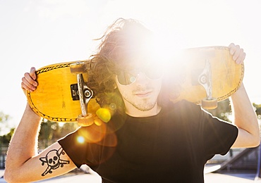 Man holding skateboard on his arms, West Palm Beach, Florida