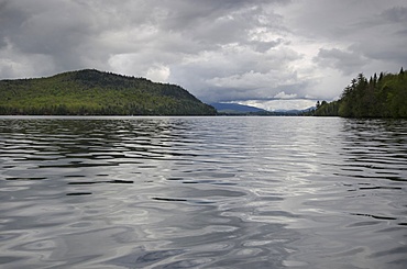 Scenic view of lake on cloudy day, Lake Placid, New York