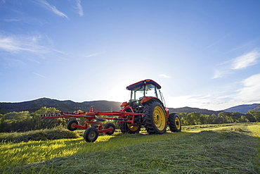 Tractor in field at sunset, Colorado