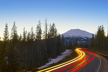 View of light trail on road in forest, Mount Bachelor, Oregon