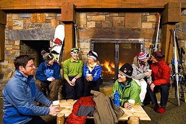 Group of skiers hanging out at fireplace, Whitefish, Montana, USA