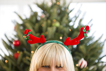 Blond woman wearing reindeer headband