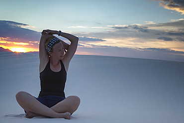 Mid-adult woman doing yoga in desert, White Sands National Monument, Alamogordo, New Mexico