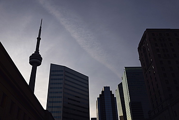 Low angle view of city architecture and communications tower, Toronto, Canada