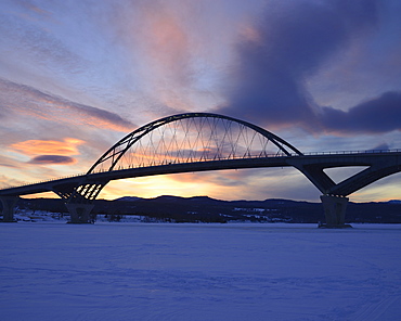 Lake Champlain Bridge linking New York and Vermont over a frozen Lake Champlain at Crown Point, snowed landscape at dusk, Crown Point, New York 