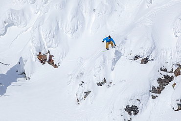 Man snowboarding down mountain, Whitefish, Montana, USA