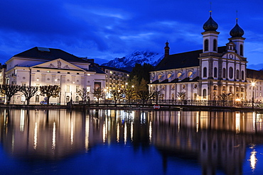 Illuminated building reflecting in lake, Lucerne, Switzerland