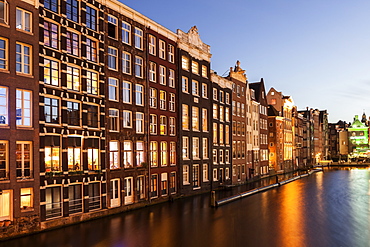 Buildings by canal at sunrise, Amsterdam, North Holland, Netherlands