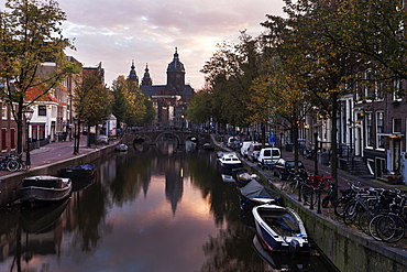 Water canal in city at sunrise, Amsterdam, North Holland, Netherlands