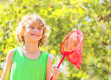 Boy (8-9) holding butterfly net