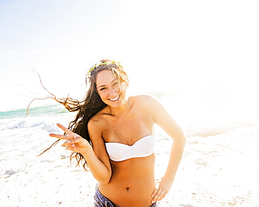 Woman on beach making victory sign, Jupiter, Florida,USA