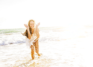 Woman on beach with arms raised, Jupiter, Florida,USA